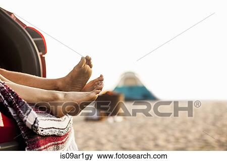Couple relaxing inside vehicle on beach View Large Photo Image Stock Photo - Couple relaxing inside vehicle on beach. Fotosearch