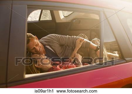 Couple relaxing inside vehicle View Large Photo Image Stock Image - Couple relaxing inside vehicle. Fotosearch