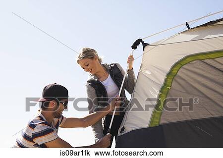 Couple setting up tent View Large Photo Image Stock Image - Couple setting up tent. Fotosearch