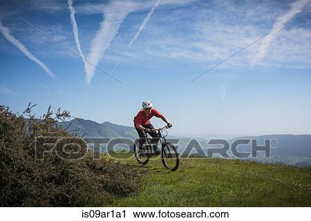Stock Image - "Cyclist mountain biking, San Luis Obispo, California, United States of America". Fotosearch