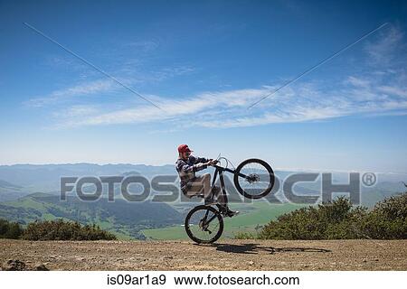"Cyclist pivoting on back wheel, San Luis Obispo, California, United States of America" View Large Photo Image Stock Photo - "Cyclist pivoting on back wheel, San Luis Obispo, California, United States of America". Fotosearch