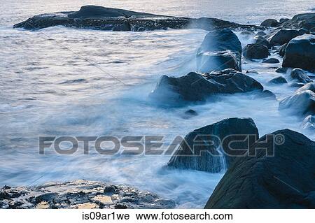 Detail of blurred tidal waves on coastal rocks View Large Photo Image Stock Image - Detail of blurred tidal waves on coastal rocks. Fotosearch