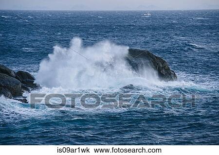 Stock Image - "Detail of ocean wave splashing over rock, Reine, Lofoten, Norway". Fotosearch