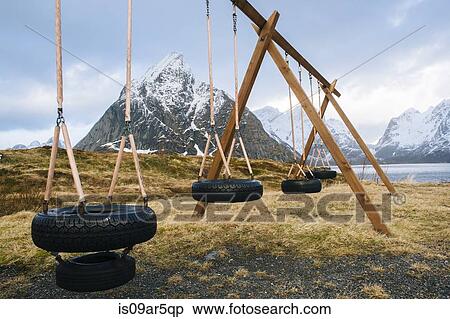Stock Photography - "Empty tire swings, Reine, Lofoten, Norway". Fotosearch