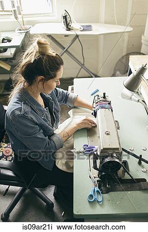 Female seamstress using sewing machine in fashion studio View Large Photo Image Stock Image - Female seamstress using sewing machine in fashion studio. Fotosearch