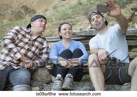 Stock Image - "Friends taking selfie, Smith Rock State Park, Oregon". Fotosearch