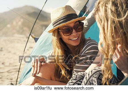 "Girlfriends relaxing beside tent, Malibu, California, USA" View Large Photo Image Stock Photograph - "Girlfriends relaxing beside tent, Malibu, California, USA". Fotosearch