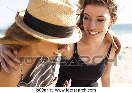 Girlfriends relaxing on beach View Large Photo Image Stock Photograph - Girlfriends relaxing on beach. Fotosearch