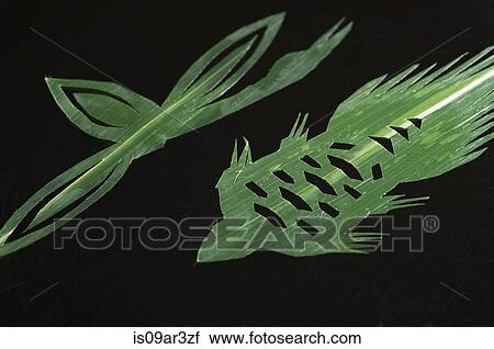 Stock Image - Green leaves cut into decorative shapes. Fotosearch