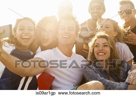 Group of friends taking selfie on beach View Large Photo Image Stock Photography - Group of friends taking selfie on beach. Fotosearch