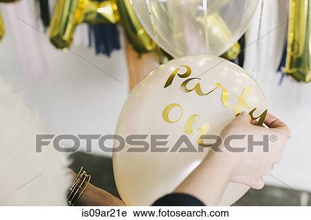 Hands of female designer applying the word party to balloon View Large Photo Image Stock Image - Hands of female designer applying the word party to balloon. Fotosearch