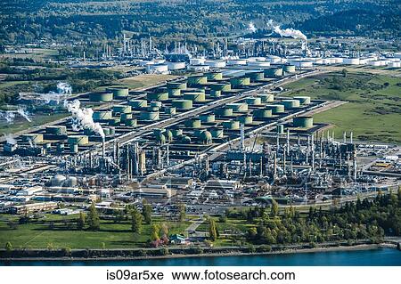 Stock Image - High angle view of green oil storage tanks in oil refinery. Fotosearch