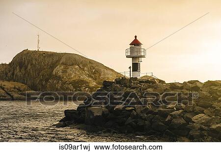 Stock Image - "Lighthouse at harbor entrance, Reine, Lofoten, Norway". Fotosearch