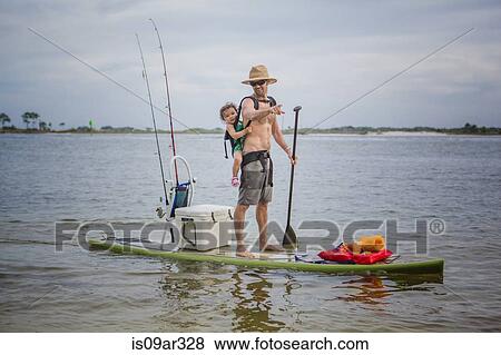 Stock Photo - "Man and baby daughter standup paddleboarding in the sound, Fort Walton, Florida, USA". Fotosearch