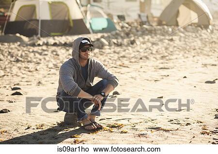 "Man at beach camp, Malibu, California, USA" View Large Photo Image Picture - "Man at beach camp, Malibu, California, USA". Fotosearch