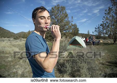 "Man brushing teeth at camp, Smith Rock State Park, Oregon" View Large Photo Image Stock Photo - "Man brushing teeth at camp, Smith Rock State Park, Oregon". Fotosearch