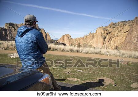 Stock Image - "Man enjoying scenery, Smith Rock State Park, Oregon". Fotosearch