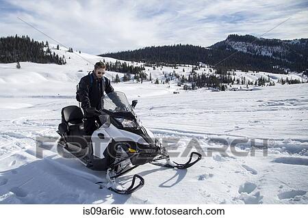 Stock Image - "Man on snowmobile, Jackson Hole, Wyoming". Fotosearch