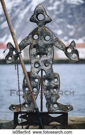 Stock Image - Metal sculpture of person with fishing rod. Fotosearch