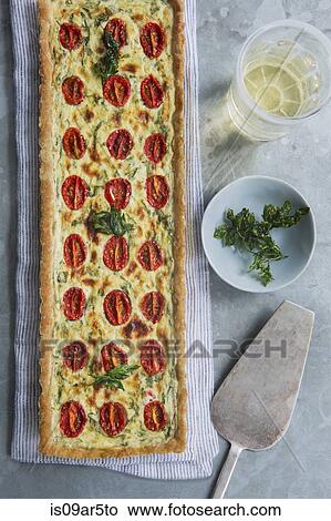 Picture - Overhead view of quiche with tomato and herb garnish. Fotosearch