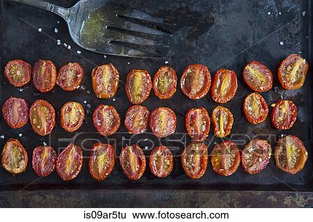 Overhead view of rows of halved roasted tomatoes on baking tin View Large Photo Image Stock Photograph - Overhead view of rows of halved roasted tomatoes on baking tin. Fotosearch