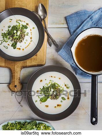 Stock Photography - Overhead view of soup in saucepan and salad with lentils. Fotosearch