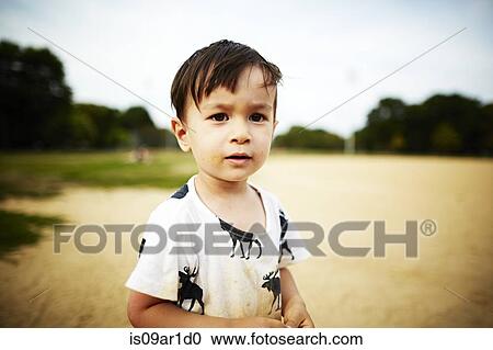 Portrait of boy standing in sand looking at camera View Large Photo Image Stock Image - Portrait of boy standing in sand looking at camera. Fotosearch