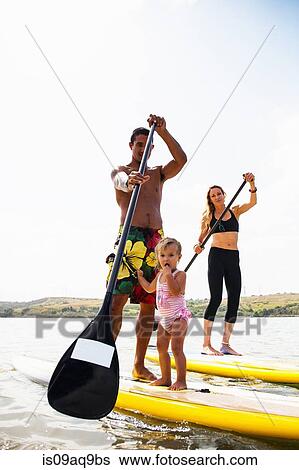 "Portrait of couple and toddler daughter standup paddleboarding, Carlsbad, California, USA" View Large Photo Image Stock Photograph - "Portrait of couple and toddler daughter standup paddleboarding, Carlsbad, California, USA". Fotosearch