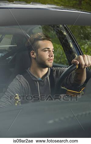 Portrait of man driving looking through windscreen View Large Photo Image Stock Image - Portrait of man driving looking through windscreen. Fotosearch
