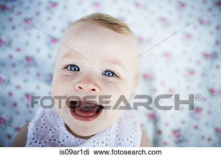 Portrait of smiling baby girl laying on mat View Large Photo Image Stock Image - Portrait of smiling baby girl laying on mat. Fotosearch