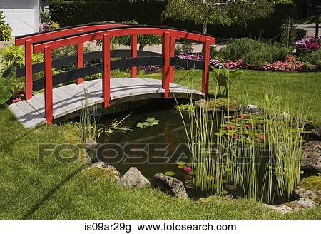 "Red and black footbridge over pond with in landscaped garden, Quebec, Canada" View Large Photo Image Stock Image - "Red and black footbridge over pond with in landscaped garden, Quebec, Canada". Fotosearch