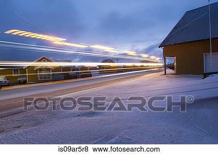 Stock Photo - "Road and buildings with motion blur, Reine, Lofoten, Norway". Fotosearch