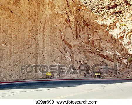 "Road with yellow direction arrows in opposite direction, Hoover Dam, Nevada, USA" View Large Photo Image Stock Photo - "Road with yellow direction arrows in opposite direction, Hoover Dam, Nevada, USA". Fotosearch