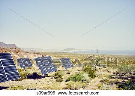 "Row of solar panels in landscape with Colorado river in distance, Hemenway Harbor, Nevada, USA" View Large Photo Image Stock Photograph - "Row of solar panels in landscape with Colorado river in distance, Hemenway Harbor, Nevada, USA". Fotosearch