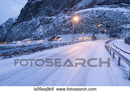 "Snow covered highway at dusk, Reine, Lofoten, Norway" View Large Photo Image Stock Photo - "Snow covered highway at dusk, Reine, Lofoten, Norway". Fotosearch