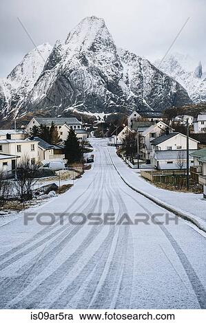 Stock Image - "Snow covered road through Reine, Lofoten, Norway". Fotosearch