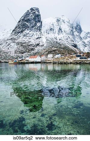 Stock Image - "Snowcapped mountain reflected in water, Reine, Lofoten, Norway". Fotosearch