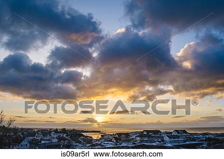 Stock Image - "Sunlight through clouds, Reine, Lofoten, Norway". Fotosearch