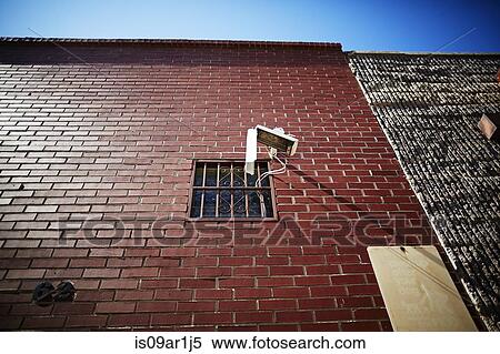 Stock Photography - Surveillance camera on red brick wall. Fotosearch