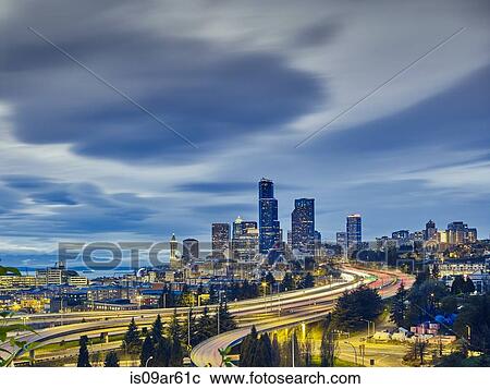 Stock Image - "Traffic light trails and cityscape at dusk, Seattle, Washington State, USA". Fotosearch