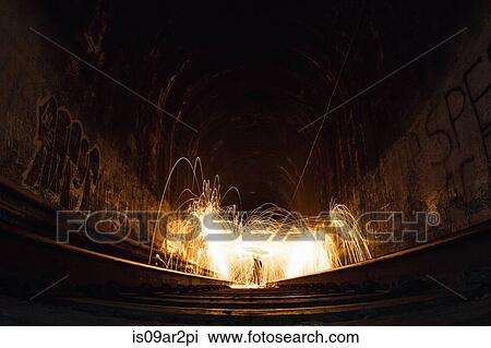 Stock Image - "Train tunnel with light trails, low angle view". Fotosearch