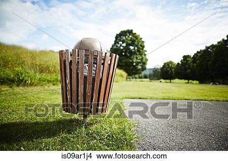 Trash bin in park View Large Photo Image Picture - Trash bin in park. Fotosearch