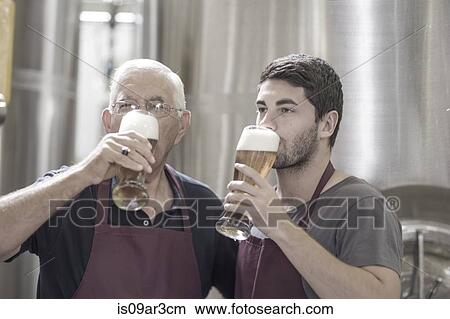 Two brewers drinking beer in the brewery View Large Photo Image Picture - Two brewers drinking beer in the brewery. Fotosearch