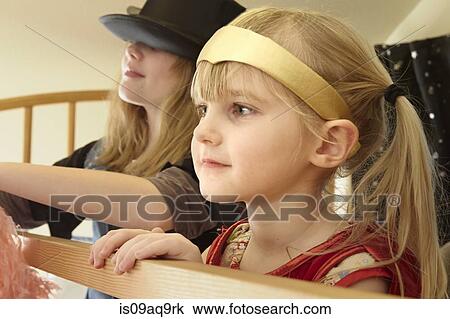 "Two sisters in fancy dress outfits, close-up" View Large Photo Image Stock Image - "Two sisters in fancy dress outfits, close-up". Fotosearch