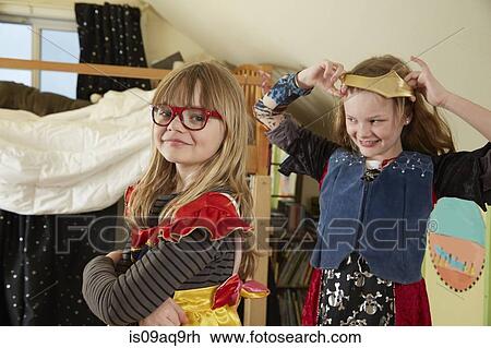 Stock Image - Two sisters playing dress up. Fotosearch