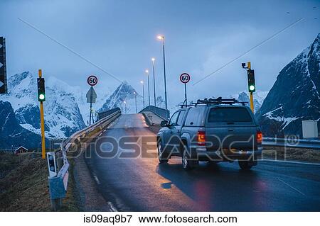 "Vehicle crossing green light bridge at dusk, Reine, Lofoten, Norway" View Large Photo Image Stock Photo - "Vehicle crossing green light bridge at dusk, Reine, Lofoten, Norway". Fotosearch