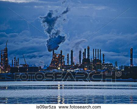 View of coastal oil refinery and smoke stacks at dusk View Large Photo Image Stock Image - View of coastal oil refinery and smoke stacks at dusk. Fotosearch