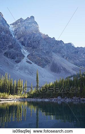 "View of mountainside and Moraine Lake at dawn, Alberta, Canada" View Large Photo Image Stock Image - "View of mountainside and Moraine Lake at dawn, Alberta, Canada". Fotosearch