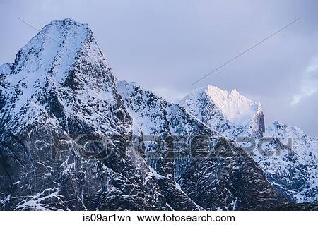 "View of snow capped mountains and storm clouds, Reine, Lofoten, Norway" View Large Photo Image Picture - "View of snow capped mountains and storm clouds, Reine, Lofoten, Norway". Fotosearch