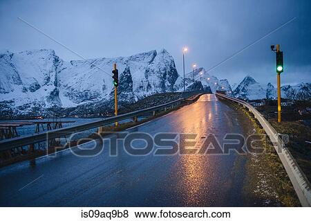 "Wet highway and green light at dusk, Reine, Lofoten, Norway" View Large Photo Image Stock Photo - "Wet highway and green light at dusk, Reine, Lofoten, Norway". Fotosearch